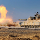 Illustration for article titled Kick ass photo of a M1 Abrams tank blasting its cannon like a fire beast